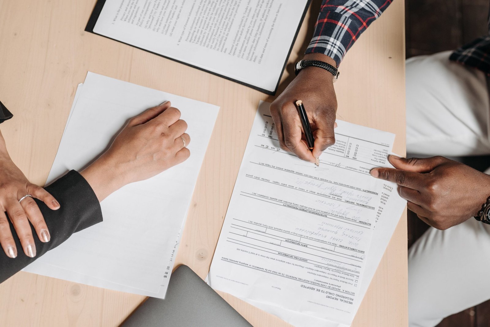 أشخاص يراجعون مستندات مالية معًا على مكتب